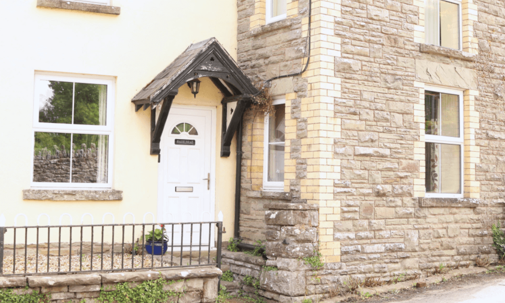 Welcoming front door and stone exterior of The Hay Holiday Cottage