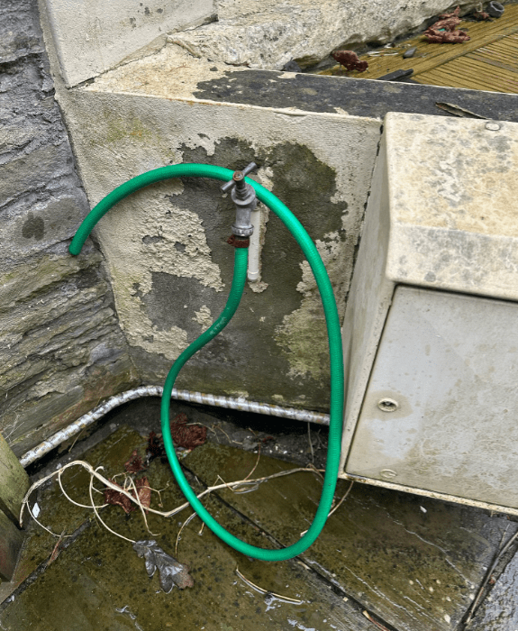 Outdoor hose station for washing muddy dogs and paws after countryside walks – dog-friendly amenity near Hay-on-Wye
